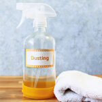 homemade dusting spray in a spray bottle with a cleaning cloth