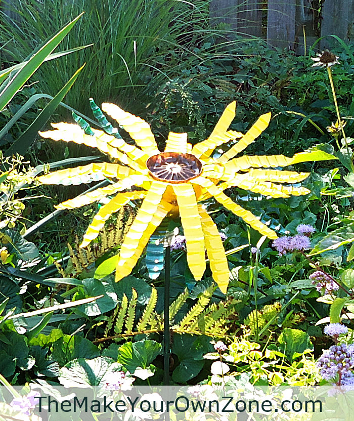 A sunflower made from recycled water bottles out in the garden