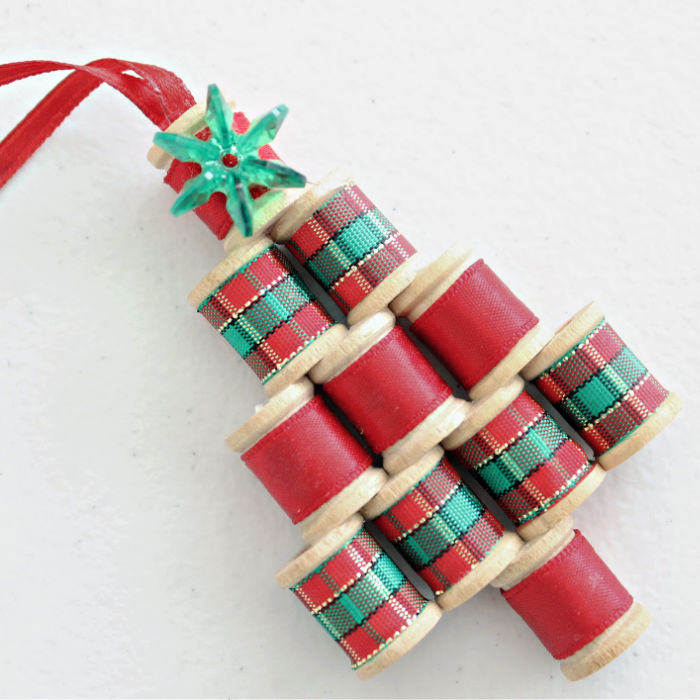 A christmas tree ornament made from mini wooden spools