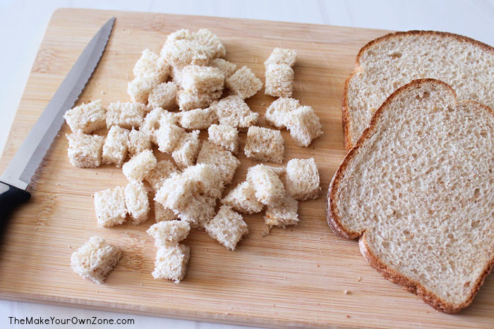 cutting bread to make homemade croutons