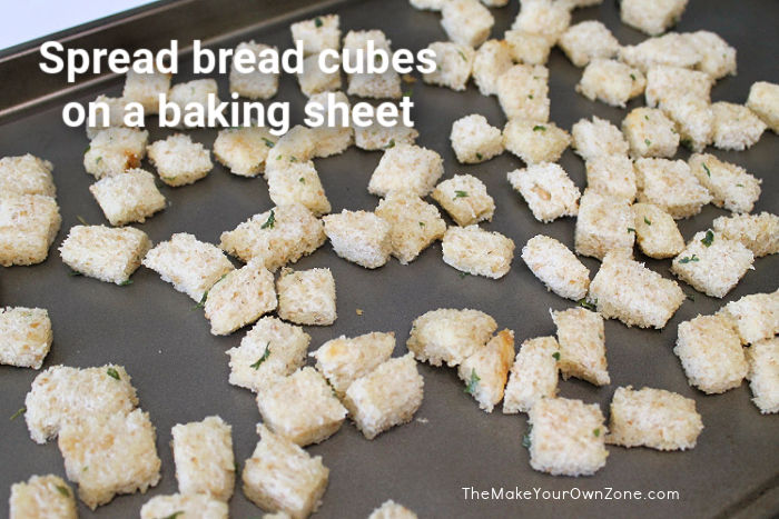 bread cubes on a baking sheet to make homemade croutons