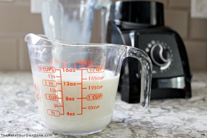 A measuring cup filled with homemade sweetened condensed milk