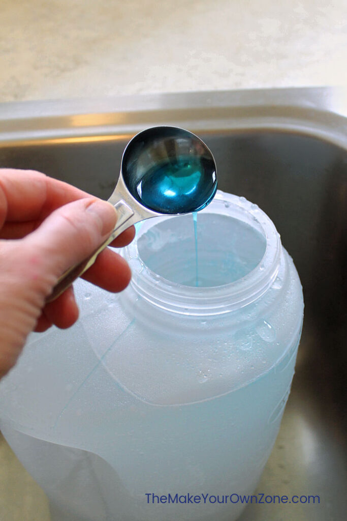 Measuring Dawn dish soap to make homemade laundry soap