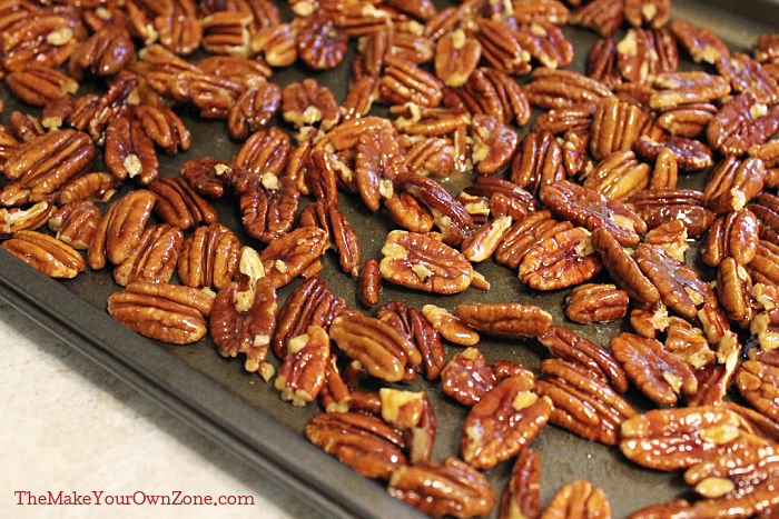 A sheet pan of spiced pecans to be toasted in the oven