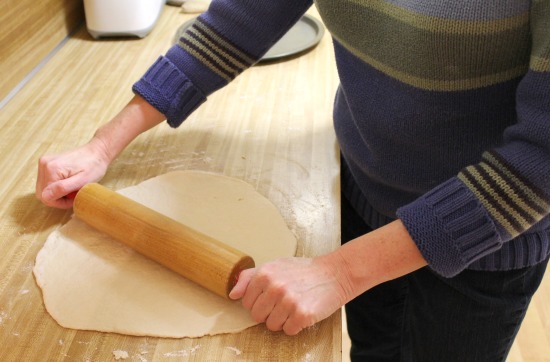 Rolling out a homemade pizza crust
