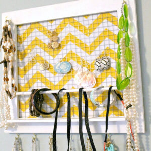 A homemade jewelry organizer made with a picture frame