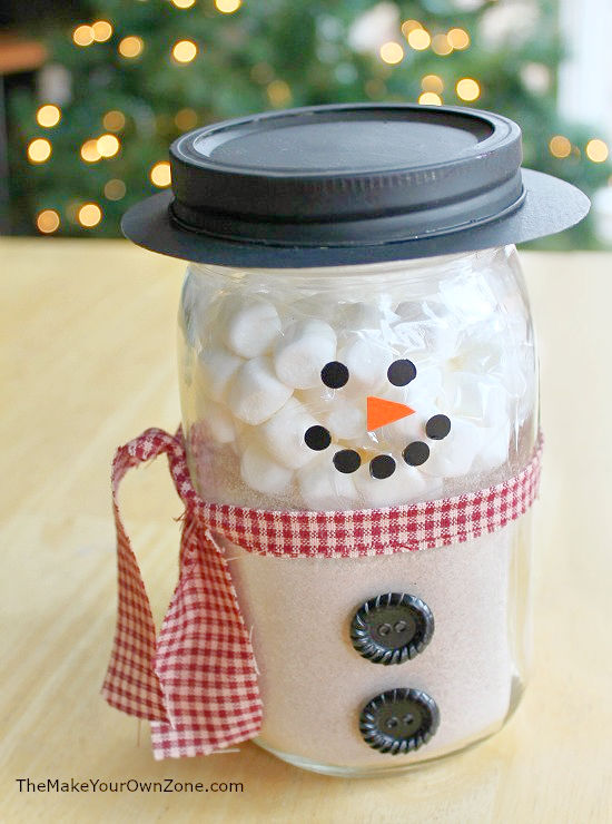 A snowman jar filled with hot chocolate mix and marshmallows
