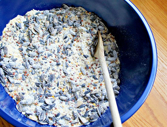 mixing ingredients to make a homemade birdseed cake