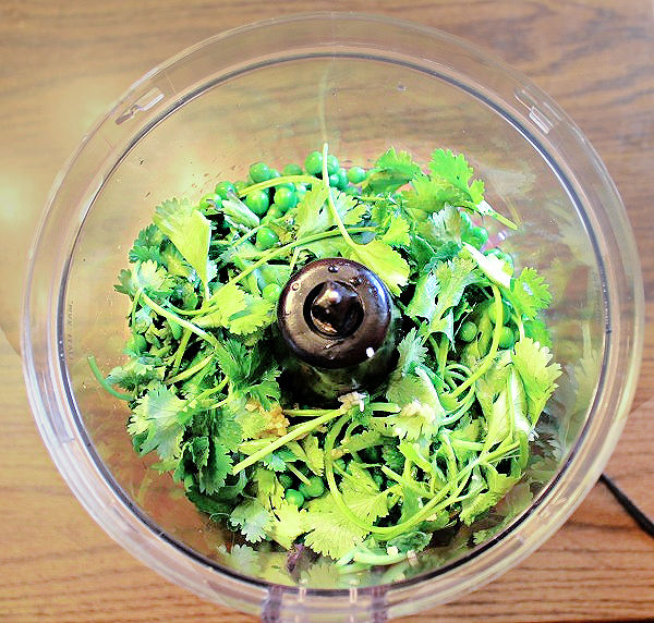 ingredients for pea guacamole in a food processor