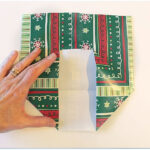 folding gift wrap to make a gift bag