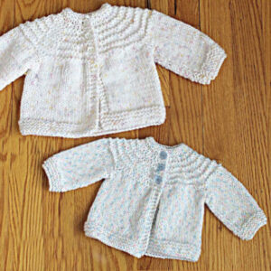 two homemade knit baby sweaters