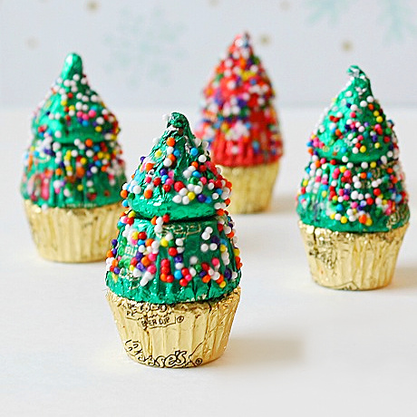 Peanut butter cups and Kisses made into mini Christmas trees