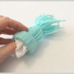 making mini yarn stocking cap ornaments