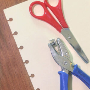 making holes in a paper for a disc bound notebook