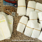 Rolling up diapers to make a diaper cake for a baby shower