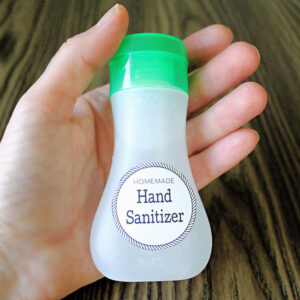 holding a bottle of DIY hand sanitizer