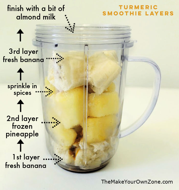 layering fruit in a magic bullet container to make a turmeric smoothie