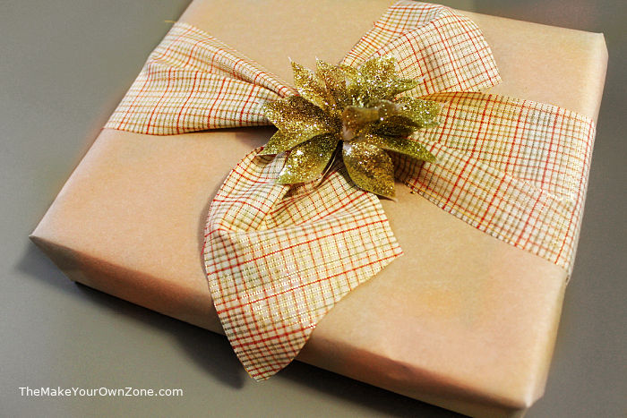 a gift wrapped box with kraft paper and fabric ribbon