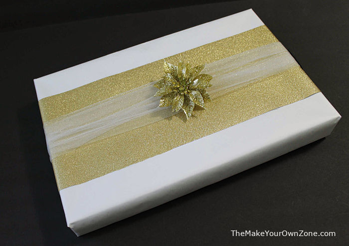 Gold and white box wrapped with freezer paper and dollar store decorations