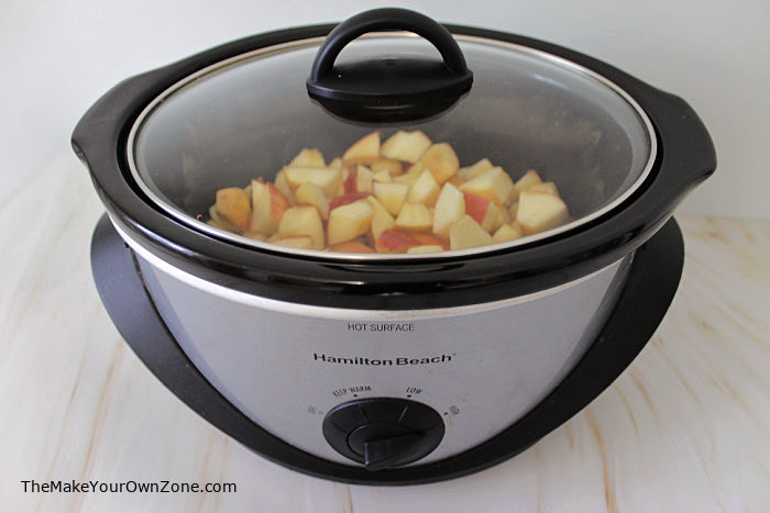 chopped apples in a crockpot to make homemade applesauce