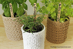 knit plant cozy with plant sticks