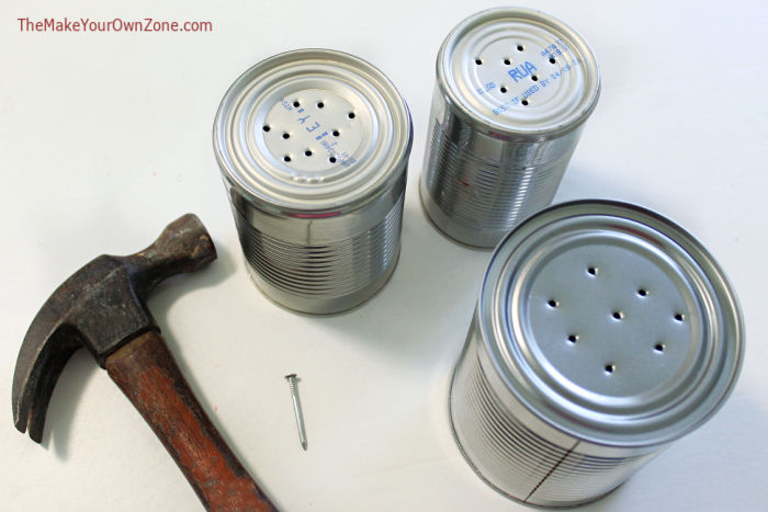 Using a hammer and nail to make drainage in tin can planters