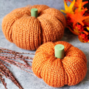 Two orange homemade knit pumpkins