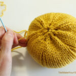 Making a knit pumpkin.