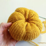 Making a knit pumpkin.