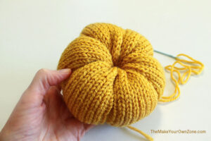 Making a knit pumpkin.