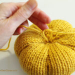 Making a knit pumpkin.