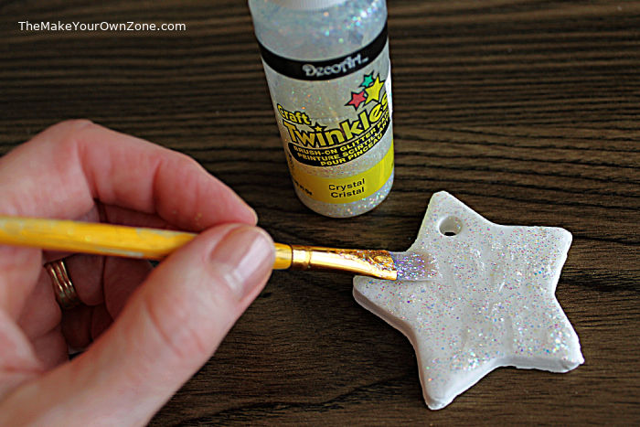 Painting a homemade baking soda ornament with twinkle glitter paint