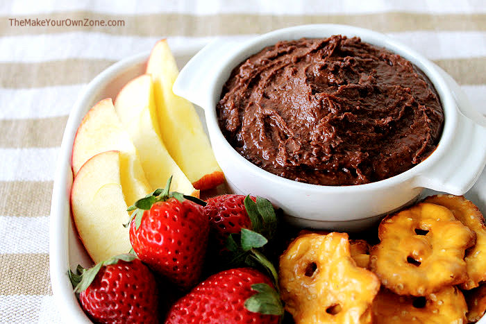 Chocolate hummus with apples, strawberries, and pretzels.