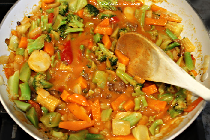 A skillet of vegetables with thai coconut curry sauce