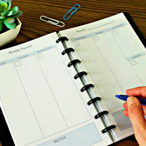 A homemade discbound planner with a printable weekly planning page