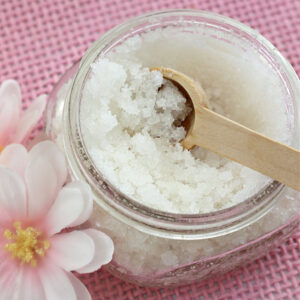 A jar of homemade sugar scrub made with coconut oil
